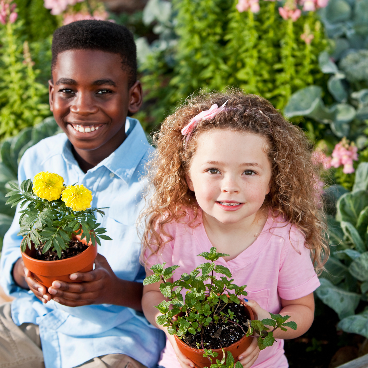 Children planting seeds in a garden